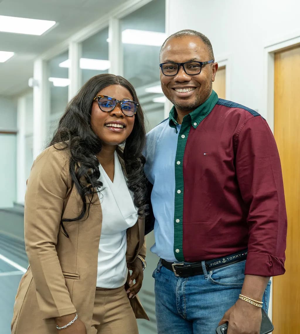 Two guests posing together and smiling in the corridor