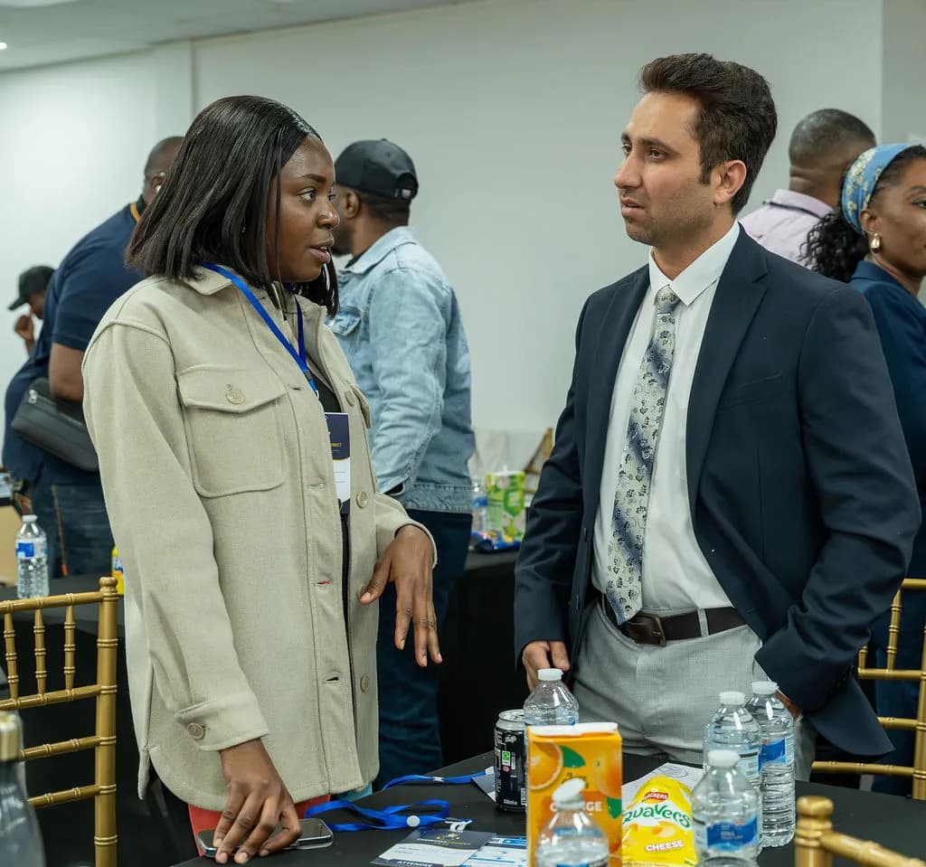 A woman and a man deep in conversation beside a table of drinks