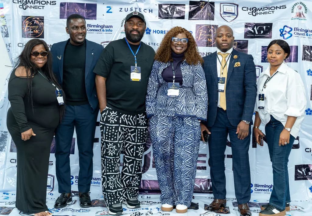 Six attendees posing together in front of the Champions Connect sponsor backdrop
